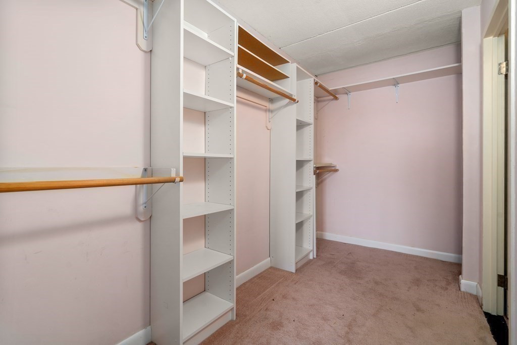 1550 Worcester Road, Unit 402 Framingham, MA 01702 - Photo 19 of 32 a view of walk in closet with empty racks