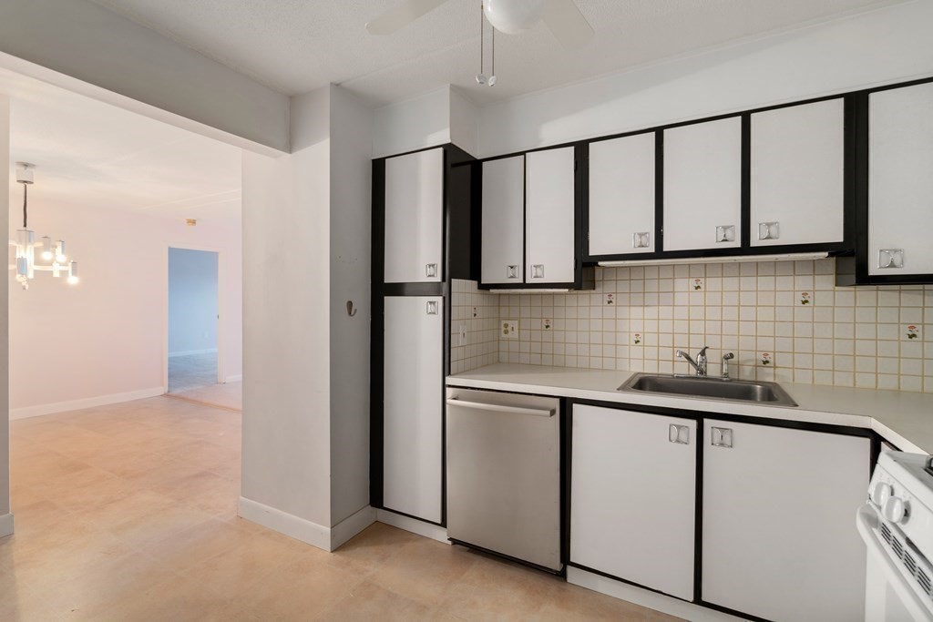 1550 Worcester Road, Unit 402 Framingham, MA 01702 - Photo 8 of 32 a kitchen with stainless steel appliances granite countertop white cabinets a refrigerator and a sink
