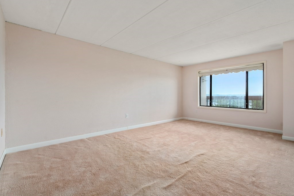 1550 Worcester Road, Unit 402 Framingham, MA 01702 - Photo 9 of 32 an empty room with windows