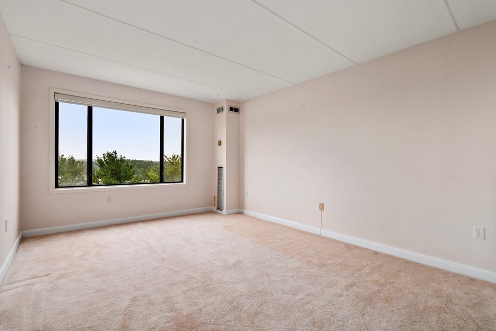 1550 Worcester Road, Unit 402 Framingham, MA 01702 - Photo 10 of 32 a view of an empty room with a window