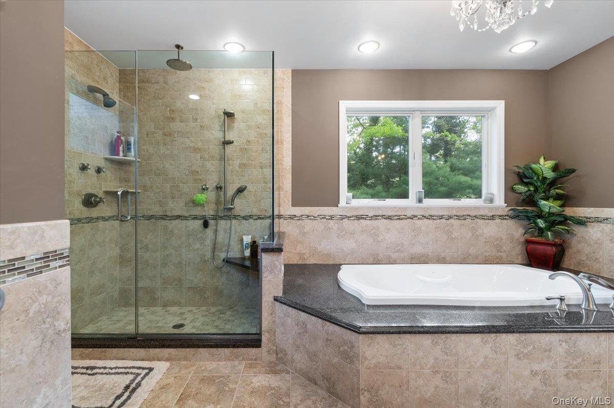 6 Apex Road Melville, NY 11747 - Photo 25 of 50 a bathroom with a tub a window and a shower