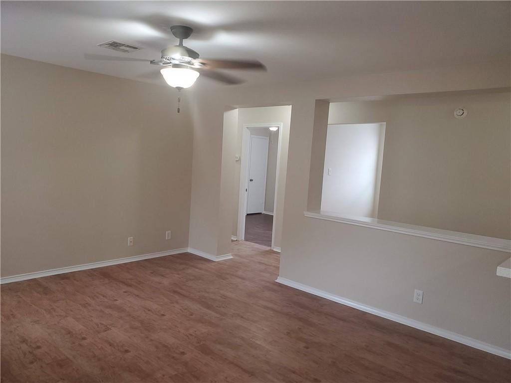 551 New Country Road Kyle, TX 78640 - Photo 11 of 34 a view of an empty room with window and wooden floor