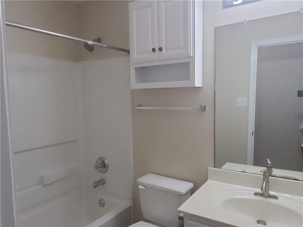 551 New Country Road Kyle, TX 78640 - Photo 20 of 34 a bathroom with a sink a toilet and shower