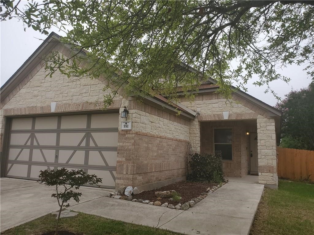 551 New Country Road Kyle, TX 78640 - Photo 2 of 34 a backyard of a house with table and chairs