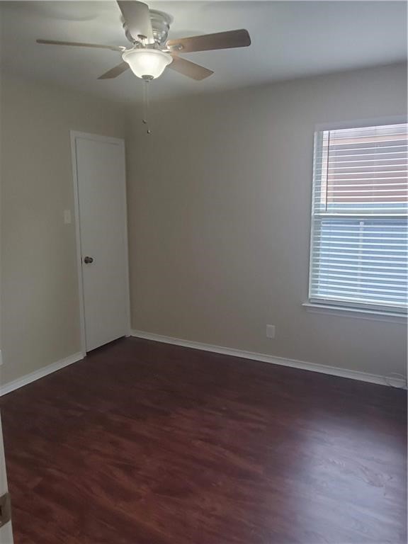551 New Country Road Kyle, TX 78640 - Photo 22 of 34 a view of an empty room with wooden floor and a window