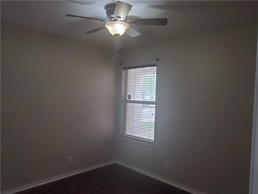 551 New Country Road Kyle, TX 78640 - Photo 25 of 34 an empty room with a window and a fan