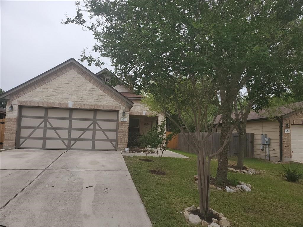 551 New Country Road Kyle, TX 78640 - Photo 32 of 34 a front view of a house with a yard and garage