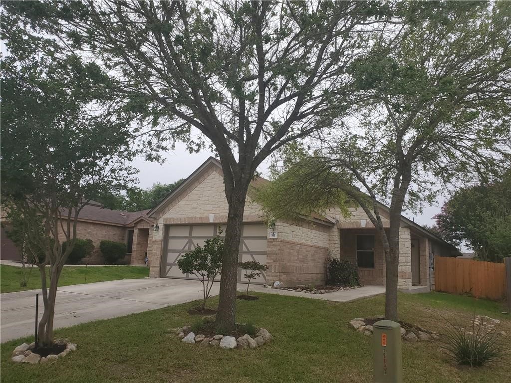 551 New Country Road Kyle, TX 78640 - Photo 33 of 34 a front view of a house with a yard and garage