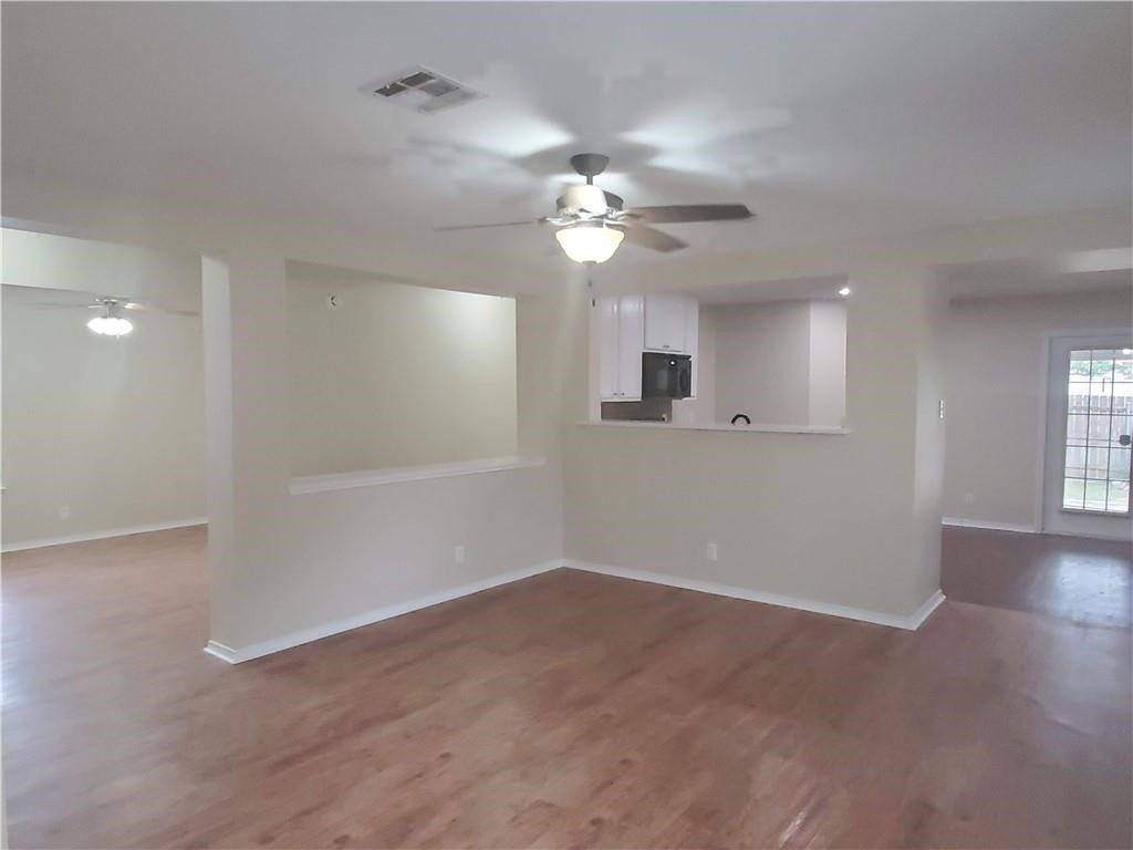 551 New Country Road Kyle, TX 78640 - Photo 4 of 34 a view of a room with a ceiling fan window and a ceiling fan