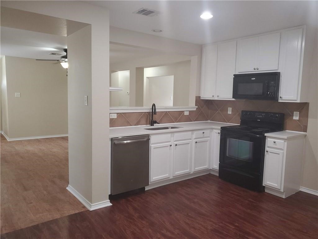 551 New Country Road Kyle, TX 78640 - Photo 6 of 34 a kitchen with a sink stove and wooden floor