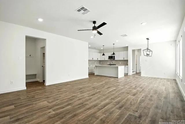 a view of a kitchen with a sink and a refrigerator