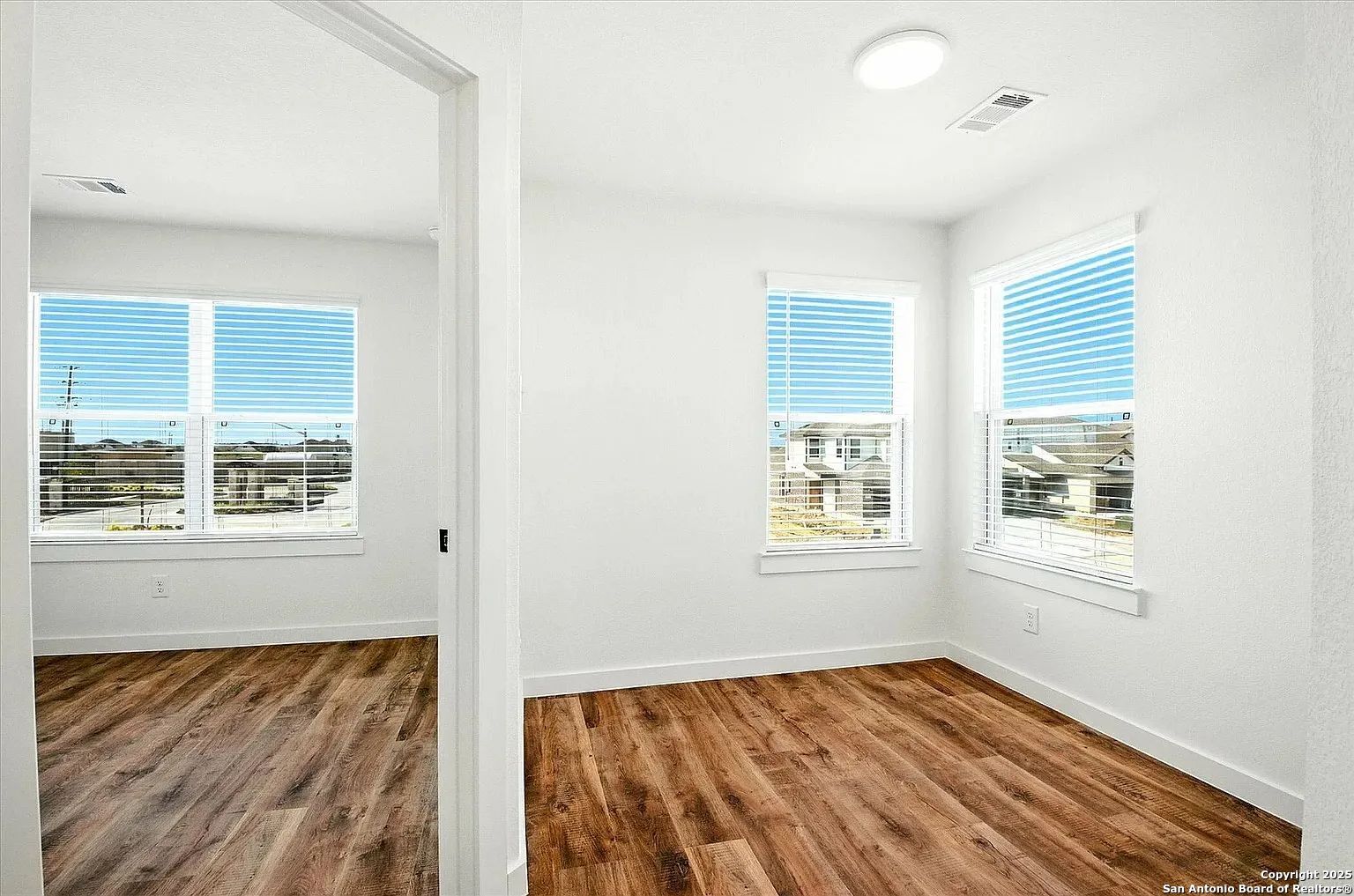 1809 North Peach Creek Drive, Unit 3C Dayton, TX 77535 - Photo 6 of 23 a view of an empty room with wooden floor and a window