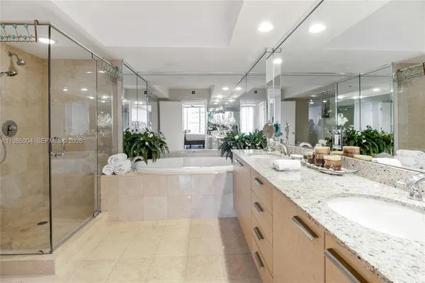 a large bathroom with a granite countertop sink mirror and shower