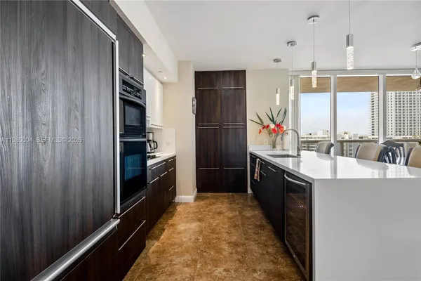 a kitchen with stainless steel appliances a sink and a refrigerator