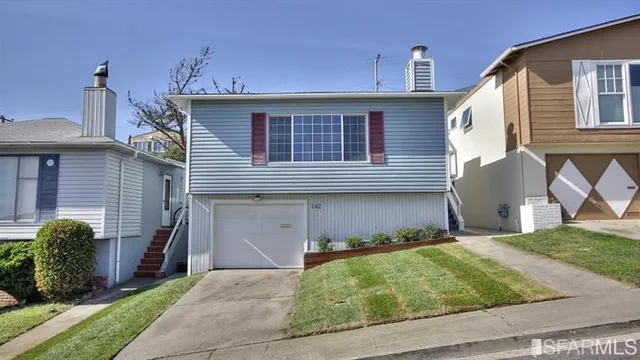 a view of a house with a yard and a large window