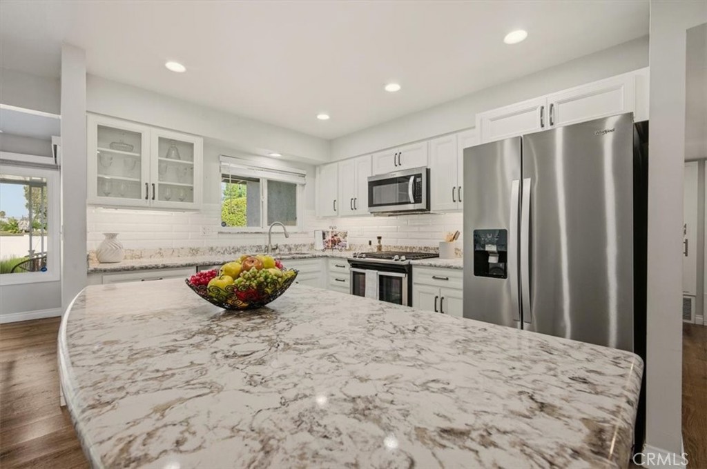29326 Carmel Road Menifee, CA 92586 - Photo 16 of 44 a kitchen with stainless steel appliances a refrigerator sink stove microwave and cabinets