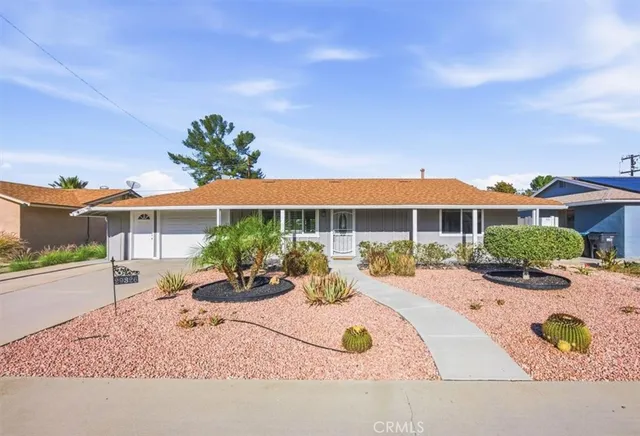 a view of a house with backyard and sitting area