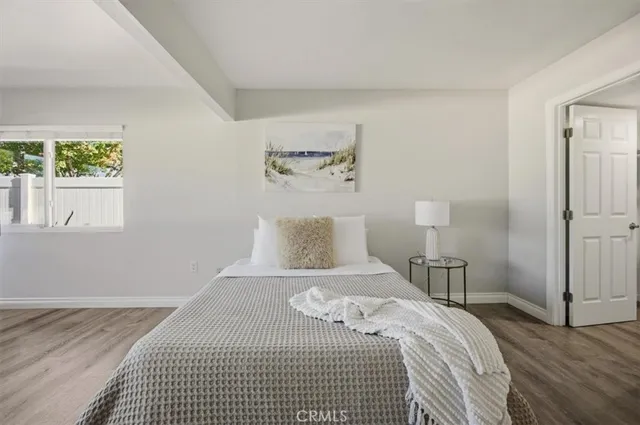 a bedroom with a bed and a night stand