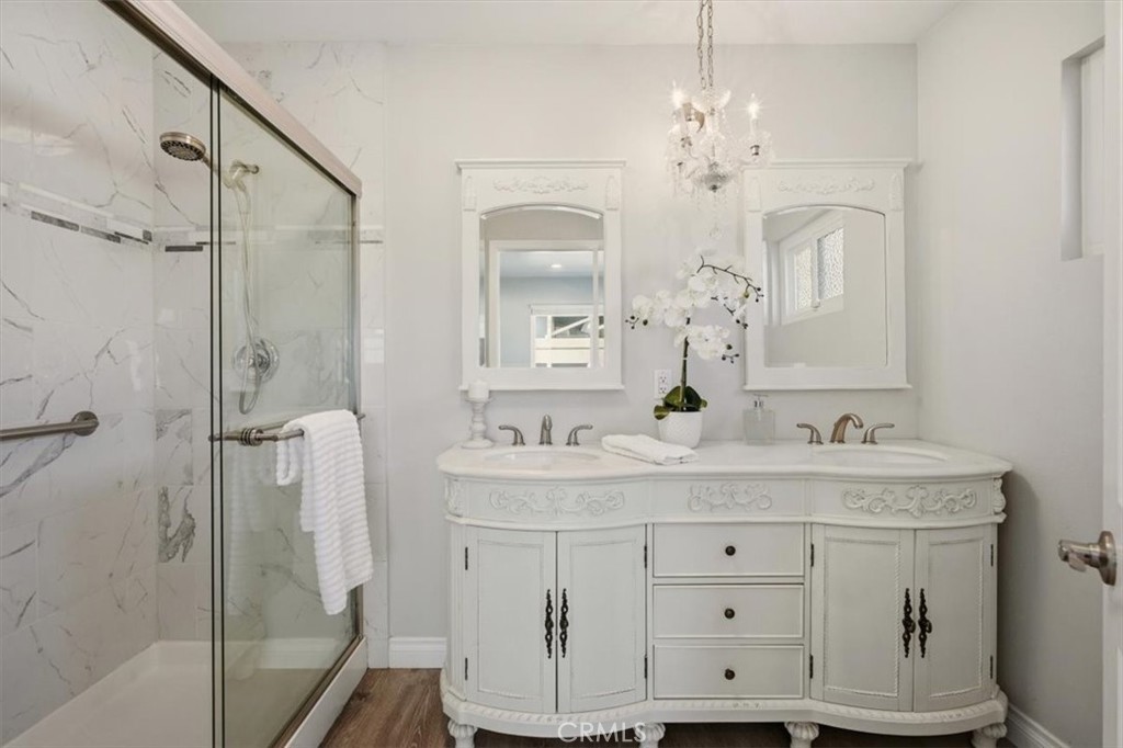 29326 Carmel Road Menifee, CA 92586 - Photo 29 of 44 a bathroom with a double vanity sink mirror and shower