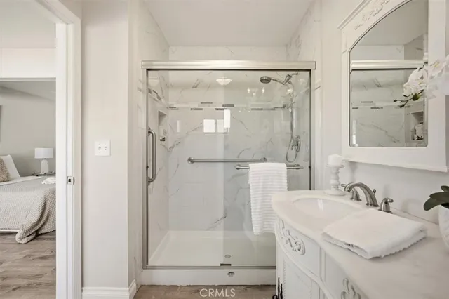 a bathroom with a granite countertop shower sink and mirror