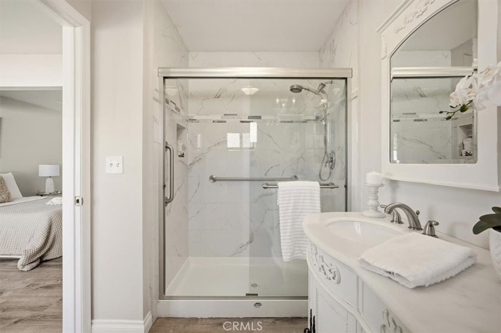 29326 Carmel Road Menifee, CA 92586 - Photo 30 of 44 a bathroom with a granite countertop shower sink and mirror