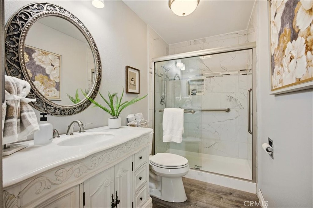 29326 Carmel Road Menifee, CA 92586 - Photo 31 of 44 a bathroom with a sink a toilet and a mirror