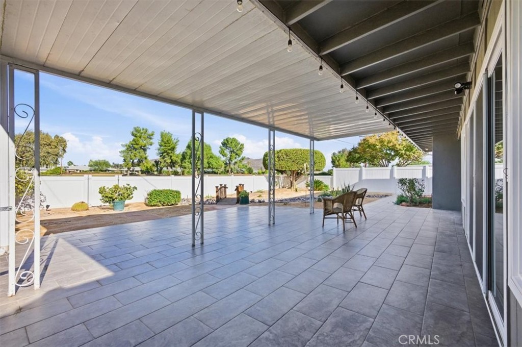 29326 Carmel Road Menifee, CA 92586 - Photo 38 of 44 a view of a patio with a table chairs potted plants and a table