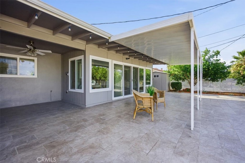 29326 Carmel Road Menifee, CA 92586 - Photo 39 of 44 a view of a patio with a table and chairs under an umbrella