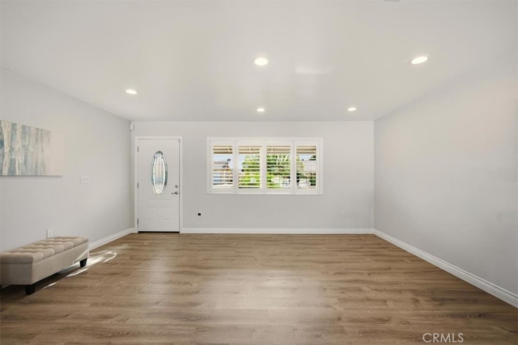 29326 Carmel Road Menifee, CA 92586 - Photo 10 of 44 a view of an empty room with wooden floor and a window