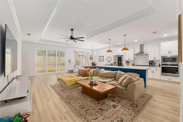 a living room with furniture and wooden floor