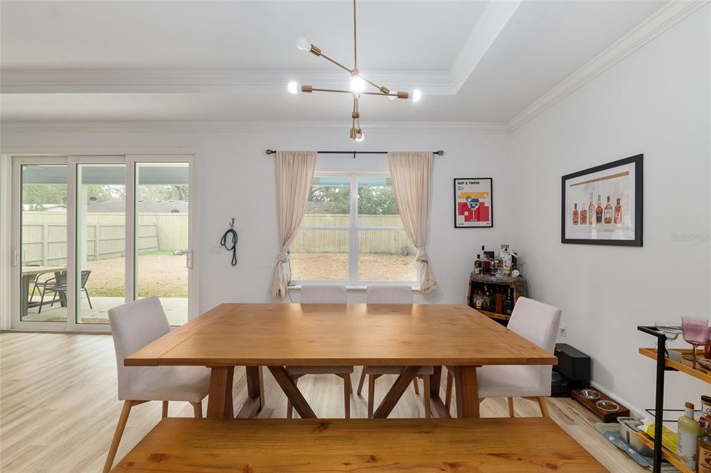 1759 Southwest 67th Circle Gainesville, FL 32607 - Photo 19 of 66 a view of a dining room with furniture window and wooden floor