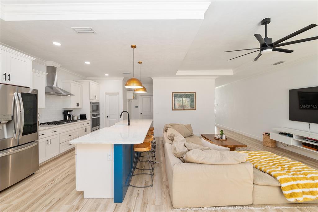 1759 Southwest 67th Circle Gainesville, FL 32607 - Photo 21 of 66 a large kitchen with stainless steel appliances kitchen island granite countertop a sink a stove and a refrigerator