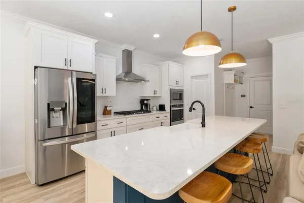 a kitchen with white cabinets and appliances