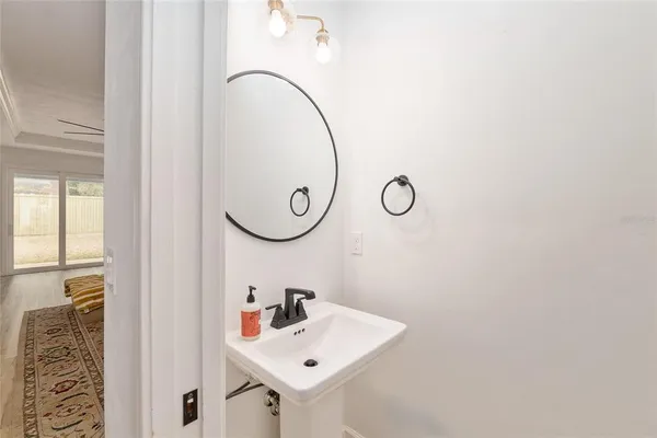 a bathroom with double vanity sinks and a mirror