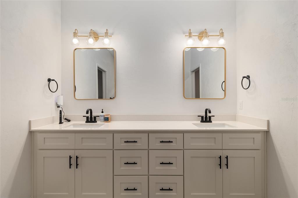 1759 Southwest 67th Circle Gainesville, FL 32607 - Photo 36 of 66 a bathroom with double vanity sinks and a mirror