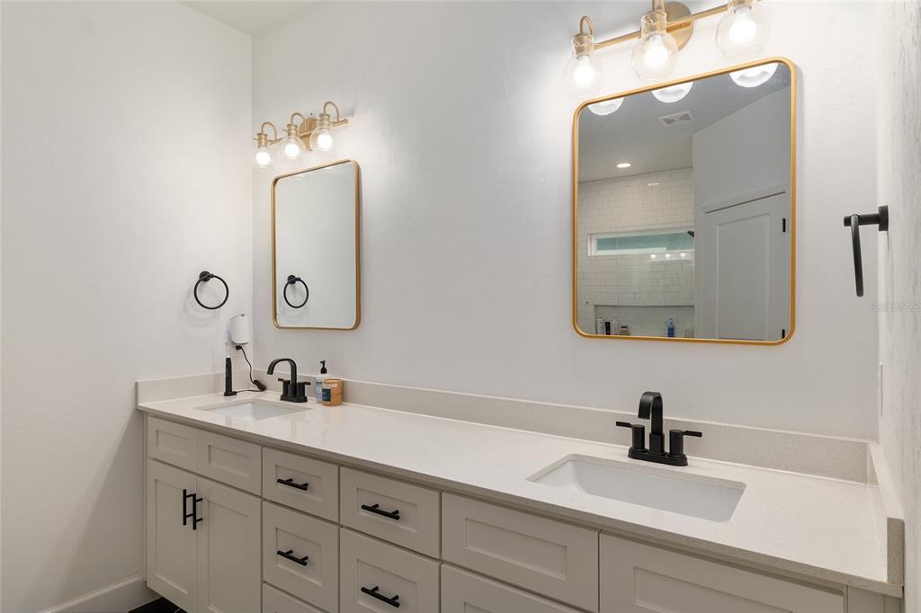 1759 Southwest 67th Circle Gainesville, FL 32607 - Photo 37 of 66 a bathroom with double vanity sinks and a mirror