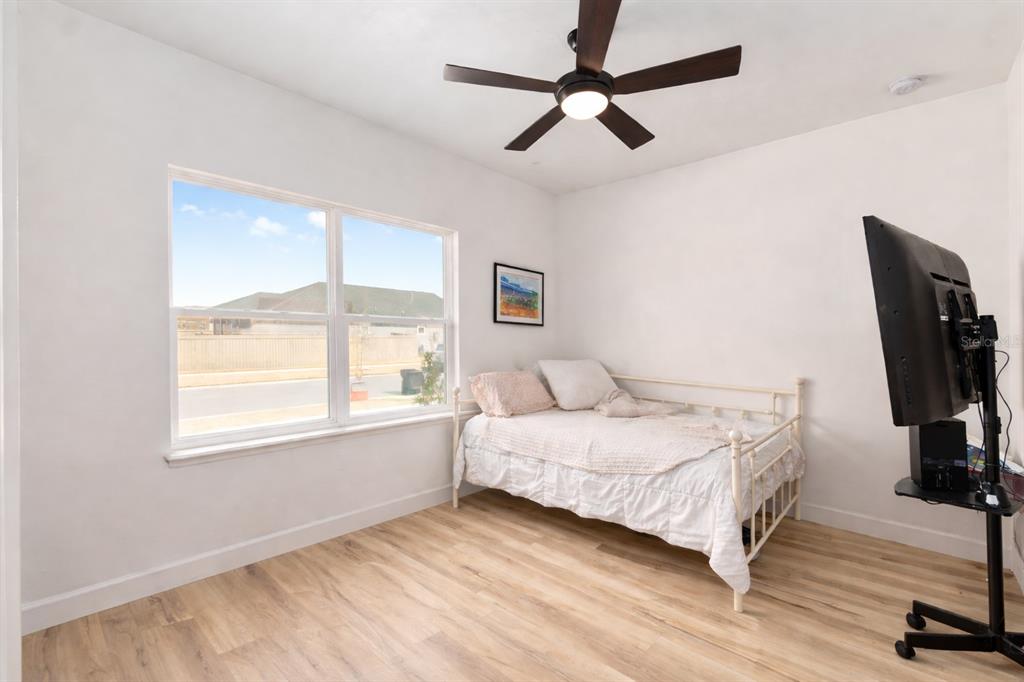 1759 Southwest 67th Circle Gainesville, FL 32607 - Photo 41 of 66 a bedroom with a bed a chandelier and a window