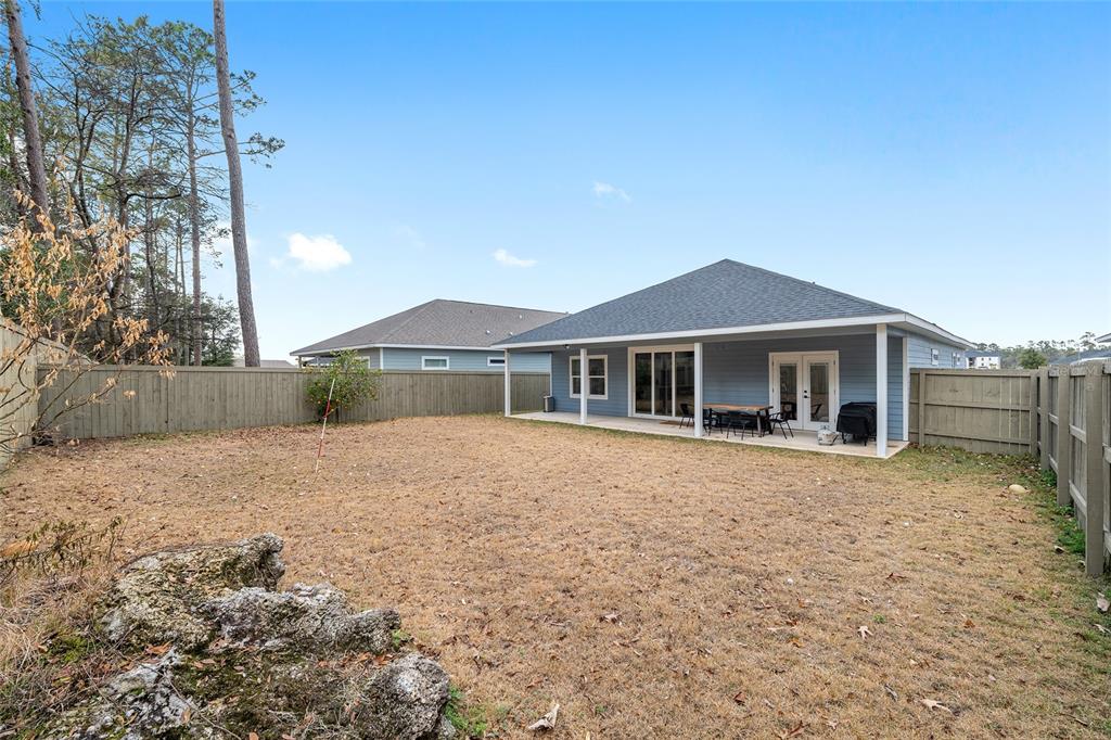 1759 Southwest 67th Circle Gainesville, FL 32607 - Photo 56 of 66 a front view of house with yard and trees in the background
