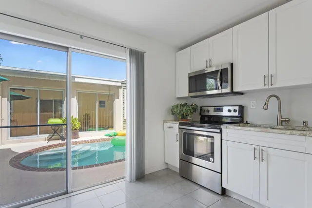 a kitchen with a sink stove and cabinets
