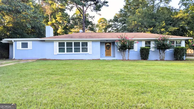 a front view of house with yard and outdoor seating