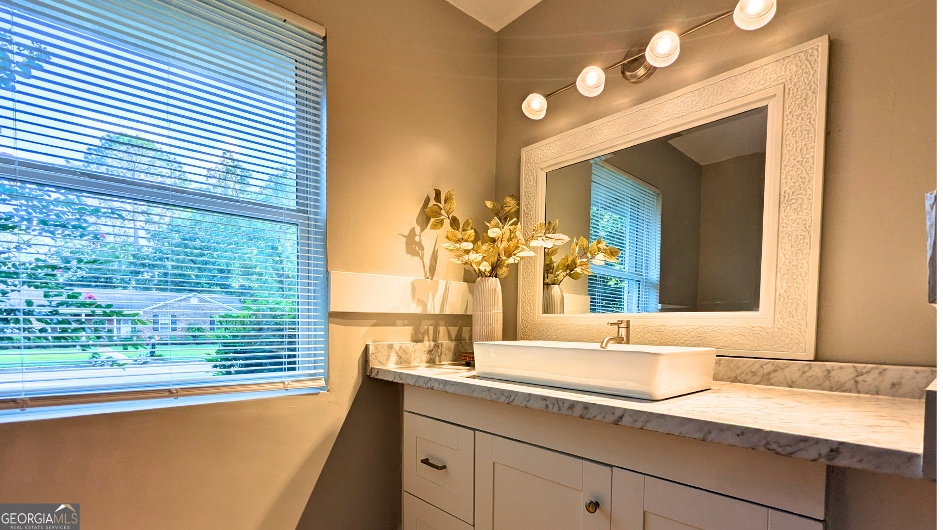 1701 Sharon Drive Albany, GA 31707 - Photo 14 of 18 a bathroom with a granite countertop sink and a large mirror