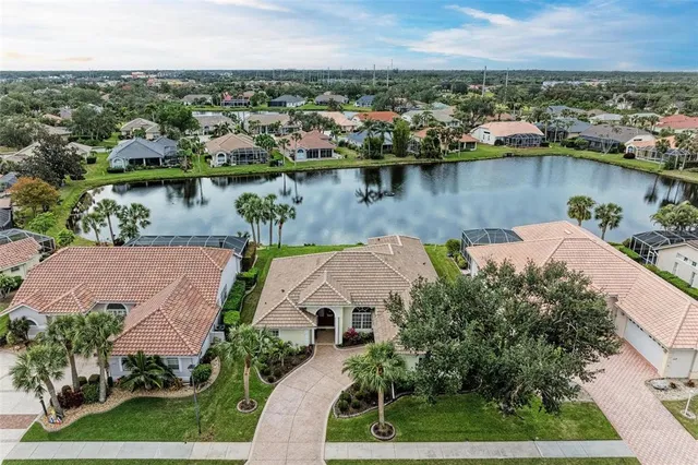 an aerial view of a house with a lake view