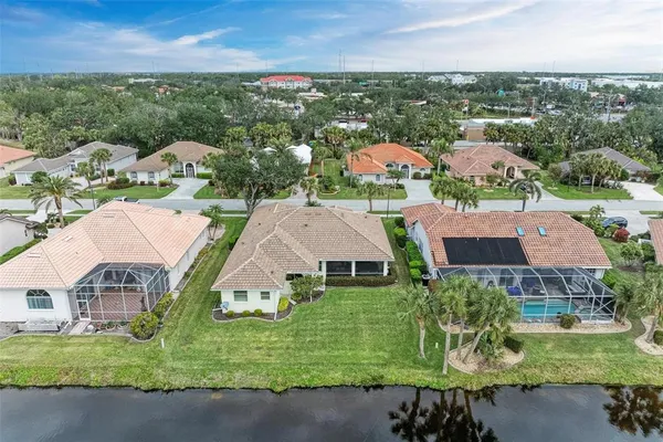 an aerial view of multiple houses with a yard