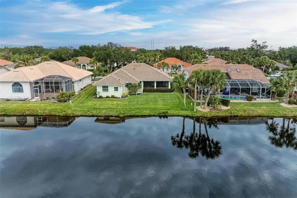a view of a house with a swimming pool and a big yard