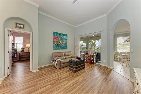 a living room with furniture and wooden floor