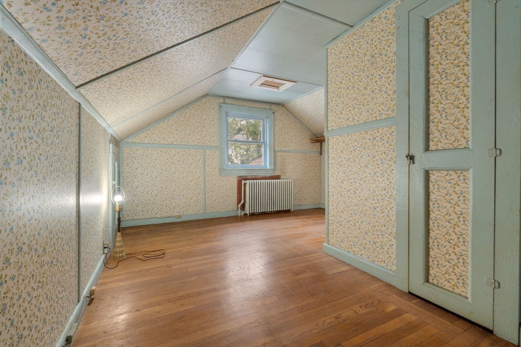 15 Atlantis Street Boston, MA 02132 - Photo 12 of 25 an empty room with wooden floor and windows