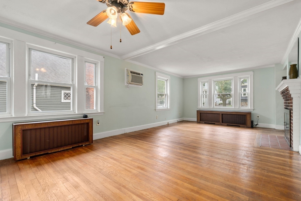 15 Atlantis Street Boston, MA 02132 - Photo 15 of 25 a view of an empty room with a window and wooden floor
