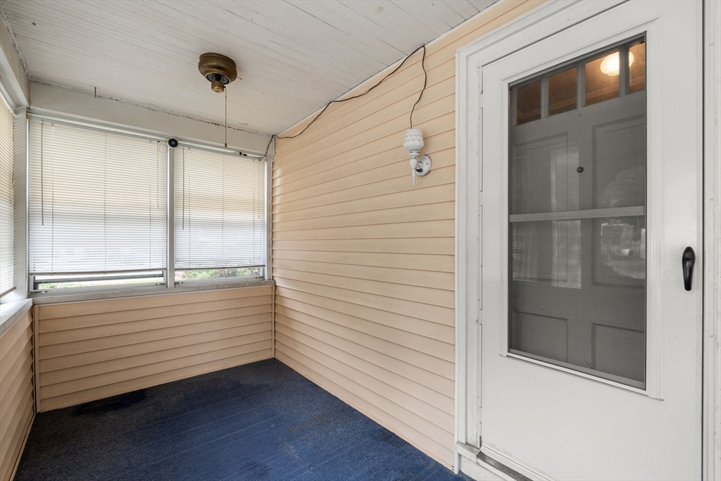 15 Atlantis Street Boston, MA 02132 - Photo 2 of 25 a view of an empty room with wooden floor and a window