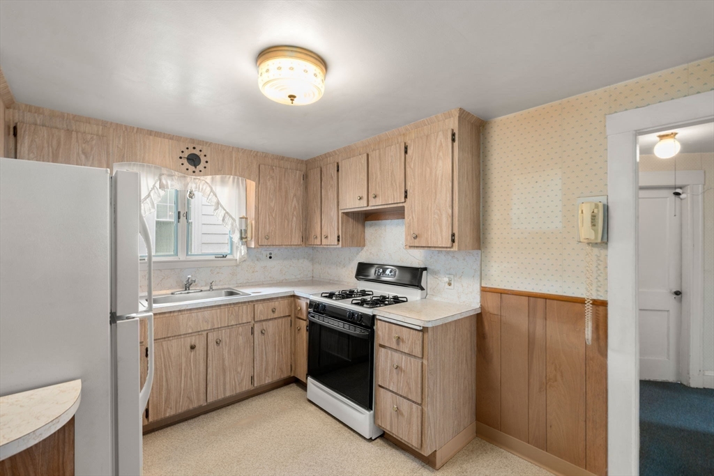 15 Atlantis Street Boston, MA 02132 - Photo 6 of 25 a kitchen with cabinets appliances a sink and a window