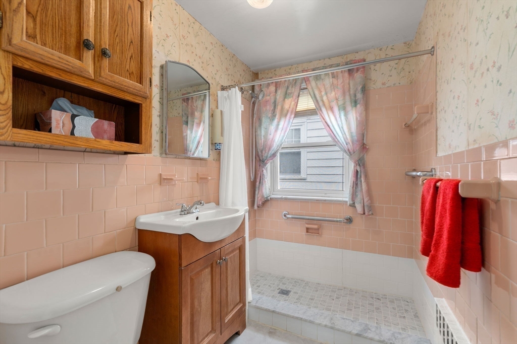 15 Atlantis Street Boston, MA 02132 - Photo 8 of 25 a bathroom with a sink a toilet and bathtub